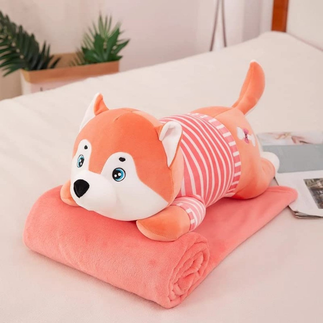 Perro de peluche con manta